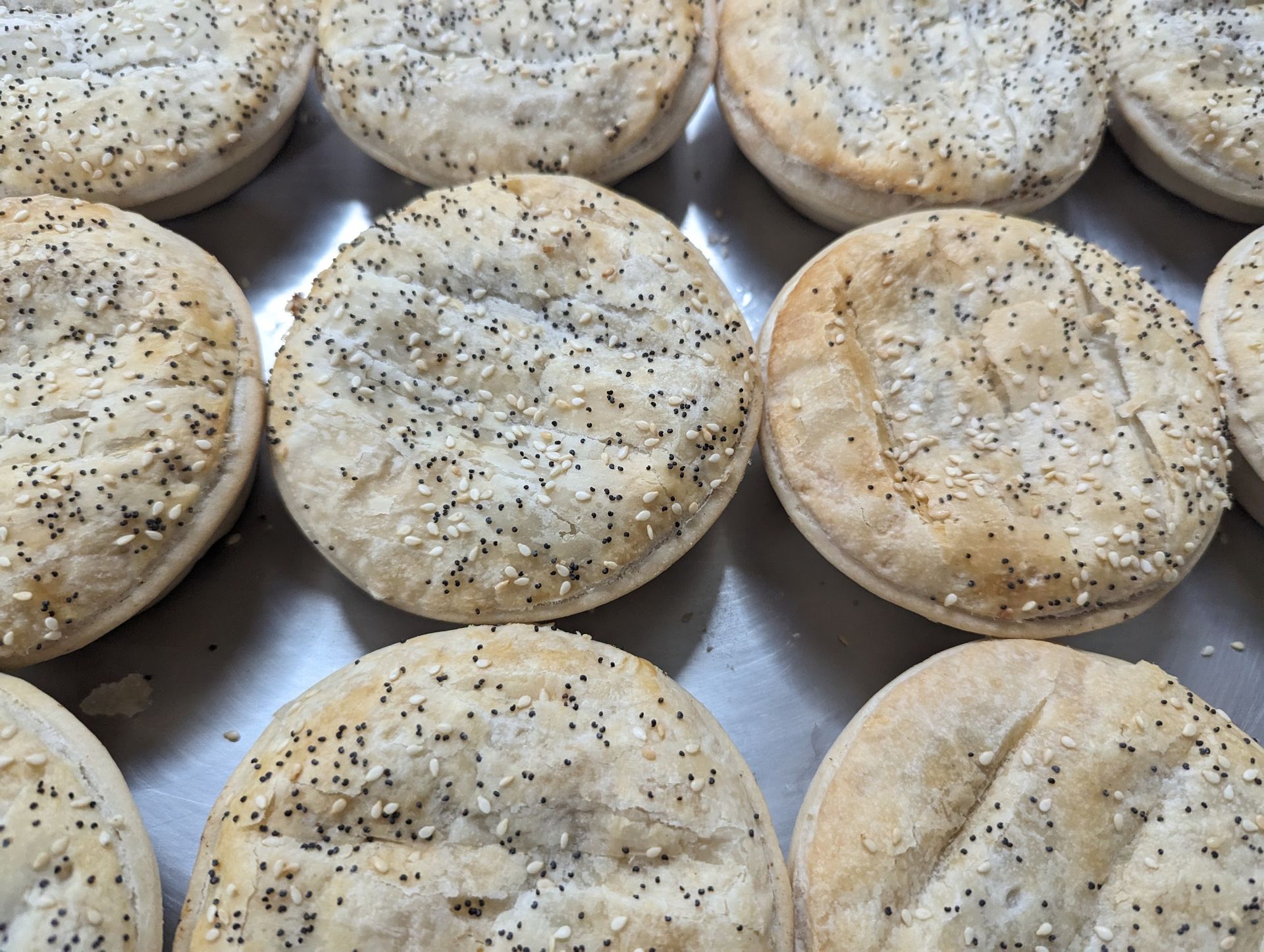 A bunch of chocolate muffins are sitting on a table.