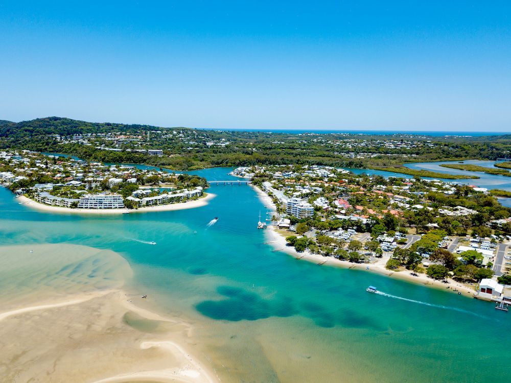 Aerial View of a Coastal Town With Turquoise Water — Creative Commercial Furniture in Sunshine Coast, QLD