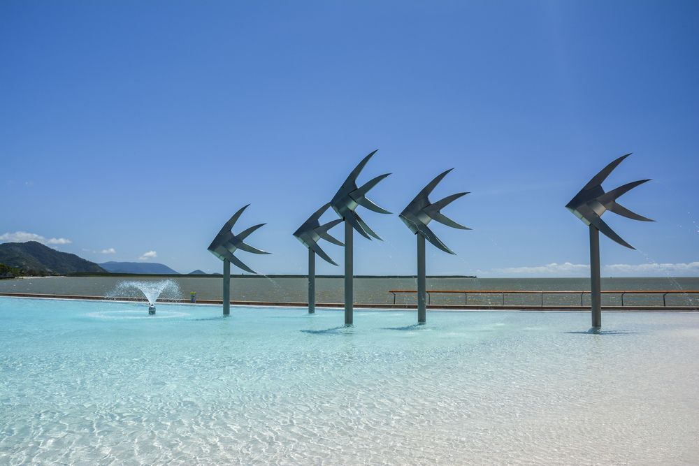 A Swimming Pool With A Fountain and Sculptures in The Shape of Birds — Creative Commercial Furniture in Cairns, QLD