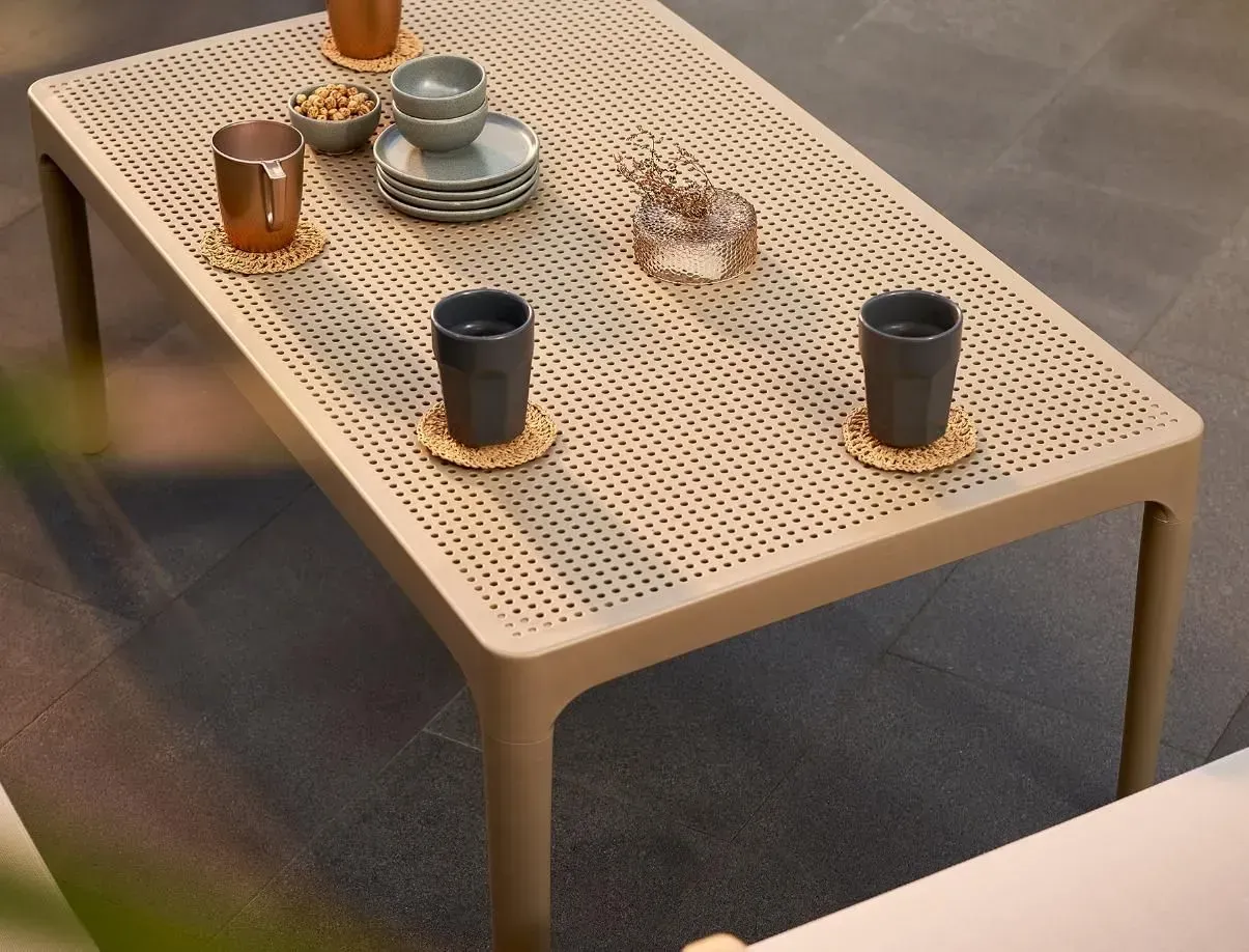 A Coffee Table with Cups and Saucers on It — Creative Commercial Furniture in Cairns City, QLD