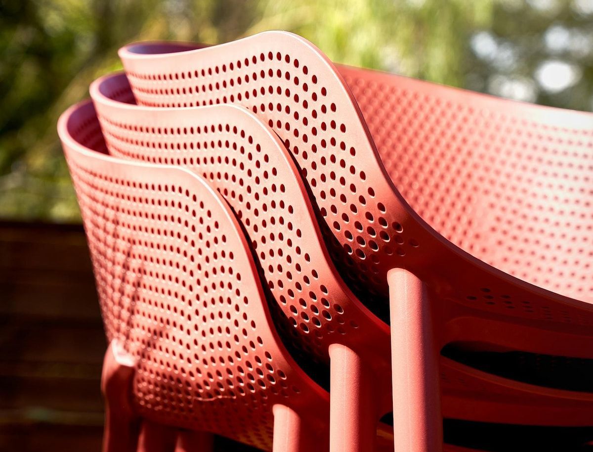 A Stack of Red Chairs Sitting on Top of Each Other — Creative Commercial Furniture in Cairns City, QLD
