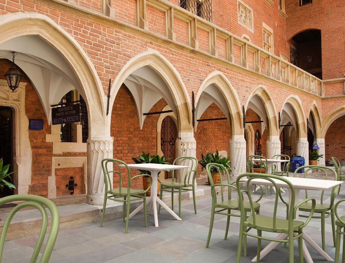 A Row of Tables and Chairs in Front of A Brick Building — Creative Commercial Furniture in Cairns City, QLD