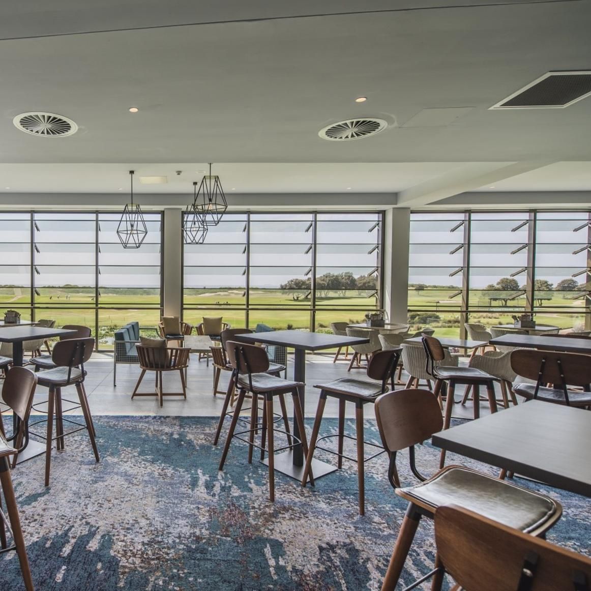 A Restaurant with Tables and Chairs and A View of A Field — Creative Commercial Furniture in Cairns City, QLD