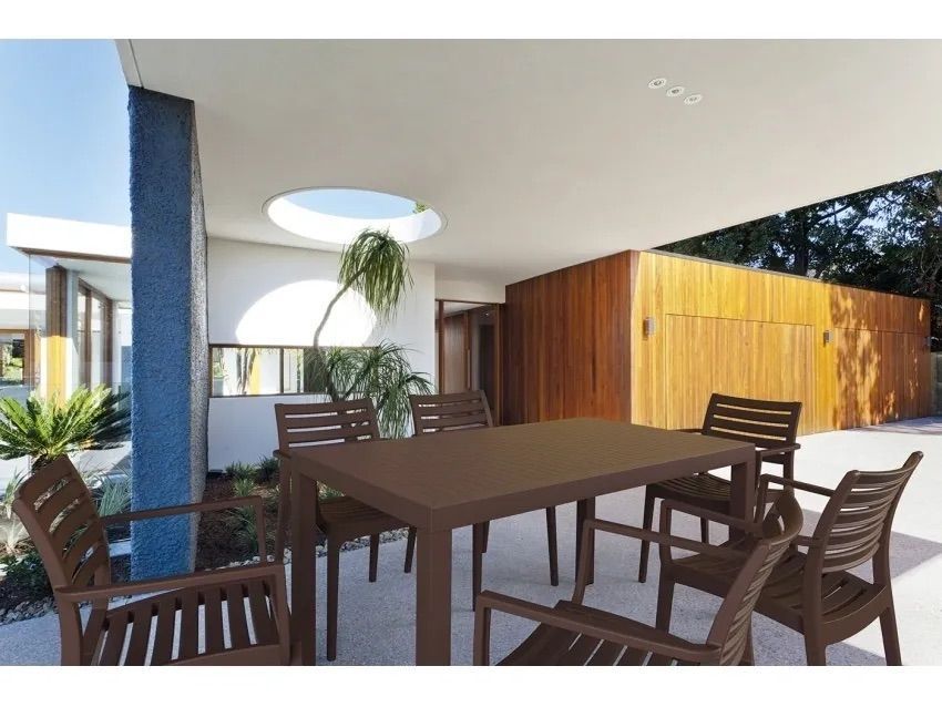 A Patio With a Table and Chairs in Front of a House β Creative Commercial Furniture in Cairns City, QLD