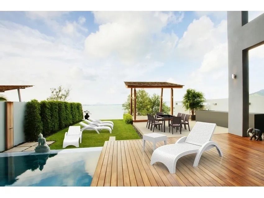 A Patio With a Table and Chairs Next to a Swimming Pool — Creative Commercial Furniture in Cairns City, QLD 