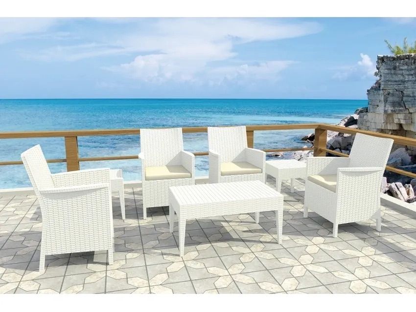A White Wicker Patio Set is Sitting on a Tiled Deck Overlooking the Ocean β Creative Commercial Furniture in Cairns City, QLD