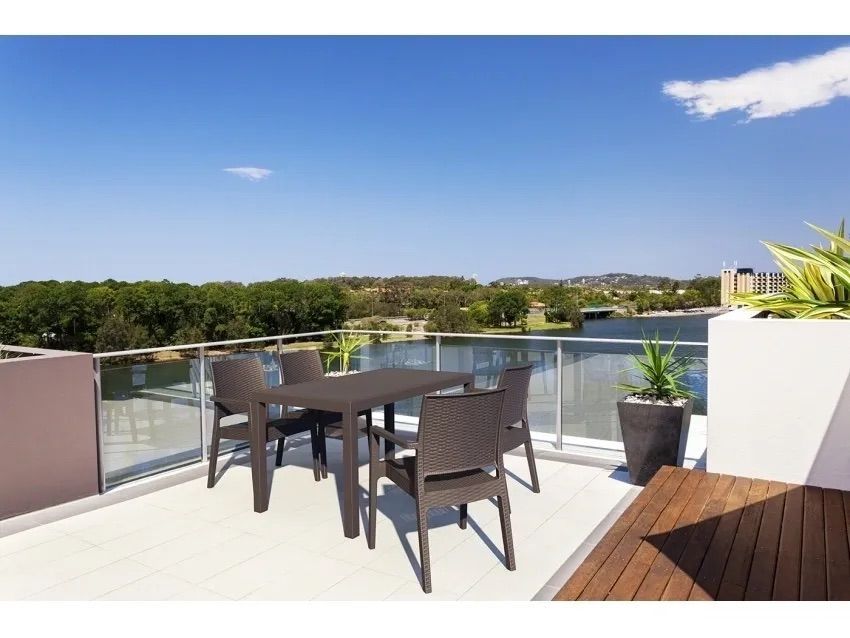 A Table and Chairs on a Balcony Overlooking a Lake β Creative Commercial Furniture in Cairns City, QLD