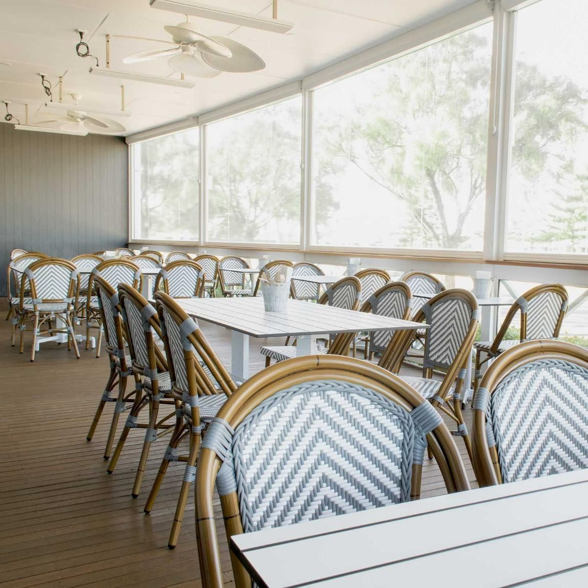 A Restaurant with Tables and Chairs and A Lot of Windows — Creative Commercial Furniture in Cairns City, QLD
