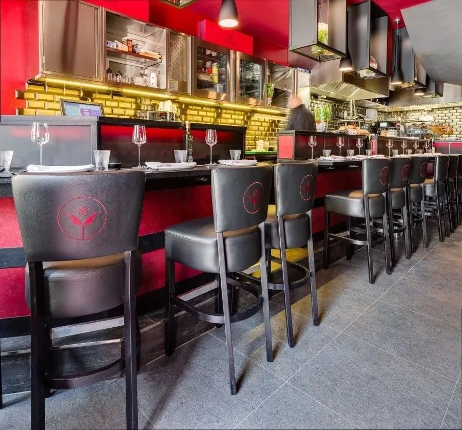 A Row of Black Bar Stools in A Restaurant — Creative Commercial Furniture in Cairns City, QLD