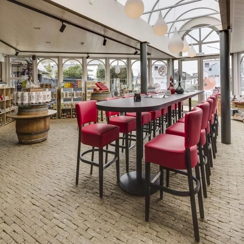 A Restaurant with A Long Table and Red Chairs — Creative Commercial Furniture in Cairns City, QLD