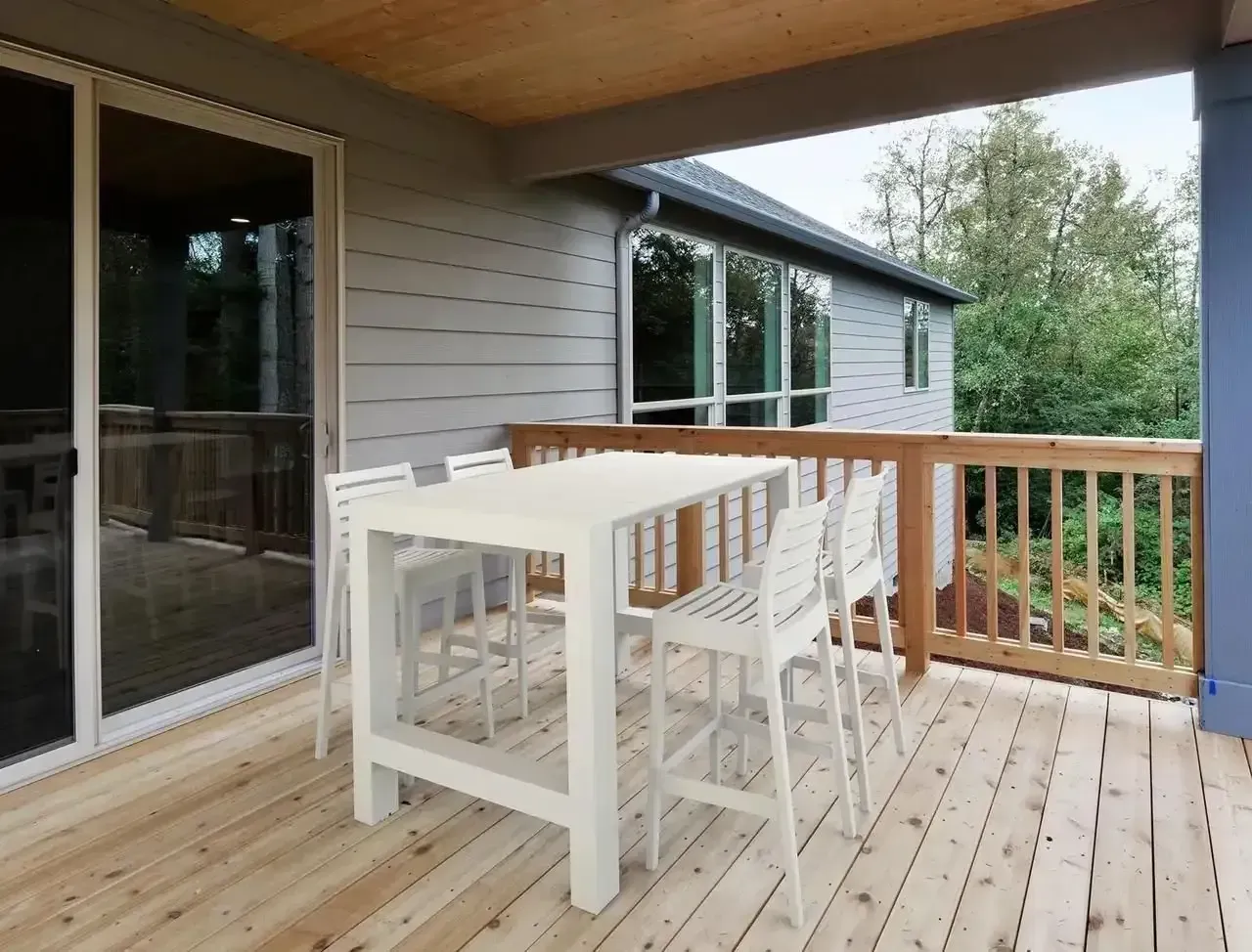 a Deck With White Table and Chairs — Creative Commercial Furniture in Sunshine Coast, QLD