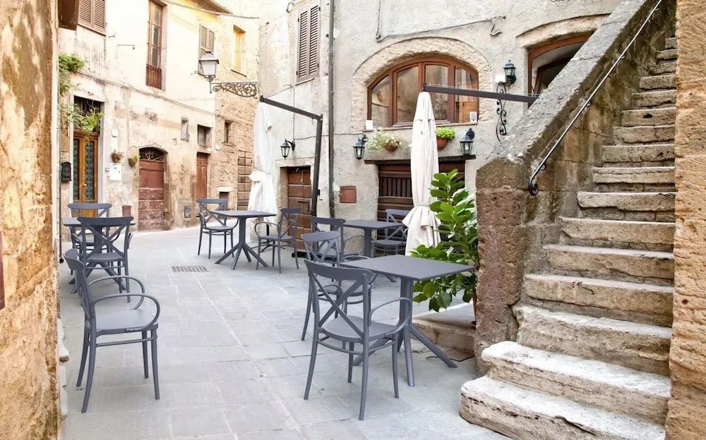 A Courtyard With Tables and Chairs and Stairs Leading Up to It — Creative Commercial Furniture in Cairns City, QLD 