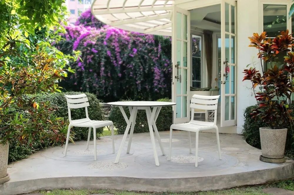 A Table and Chairs Are Sitting on a Patio in Front of a House β Creative Commercial Furniture in Cairns City, QLD