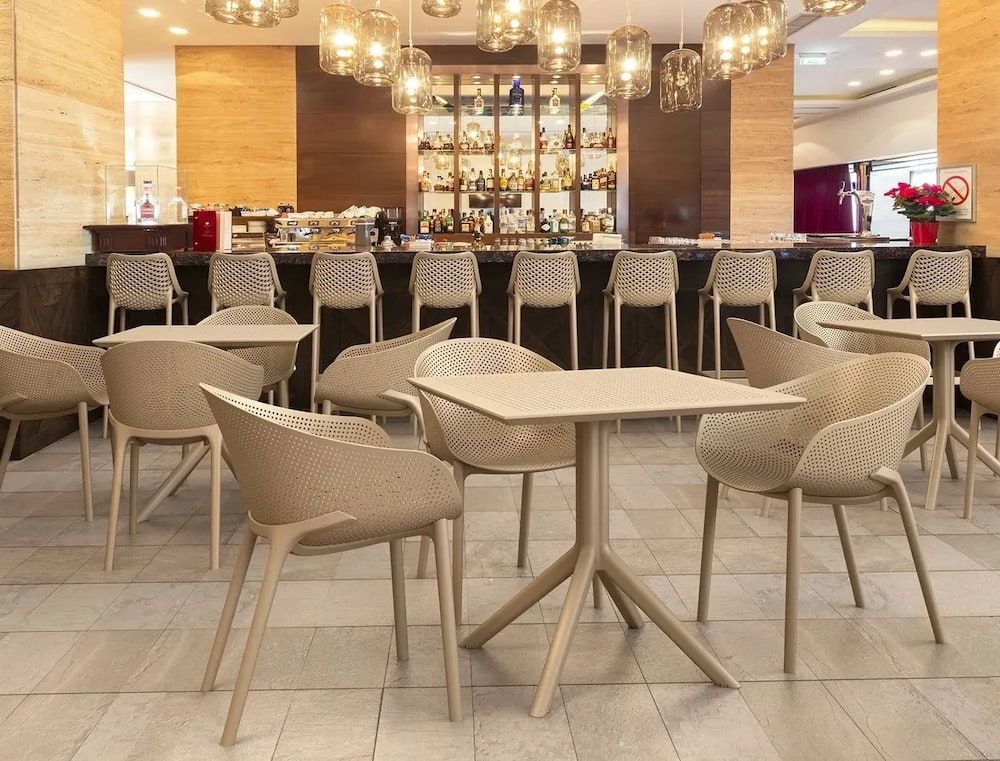 A Restaurant With Tables and Chairs and a Bar in the Background β Creative Commercial Furniture in Cairns City, QLD