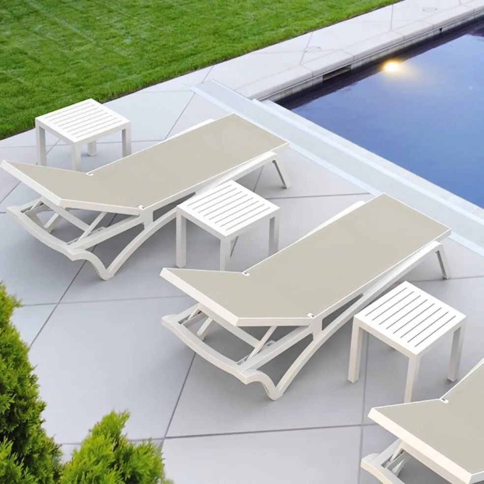 A Row of Lounge Chairs and Tables Next to a Swimming Pool β Creative Commercial Furniture in Cairns City, QLD