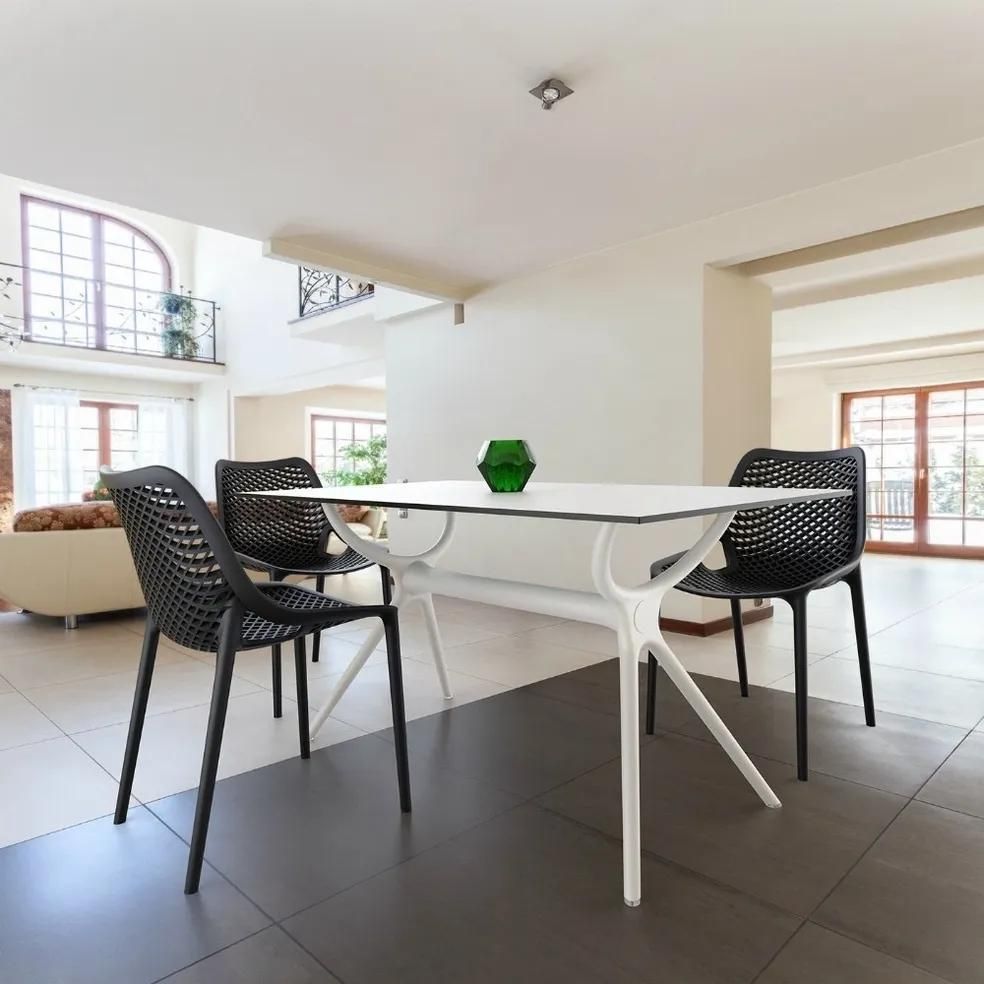 A White Table with Black Chairs in A Living Room — Creative Commercial Furniture in Cairns City, QLD
