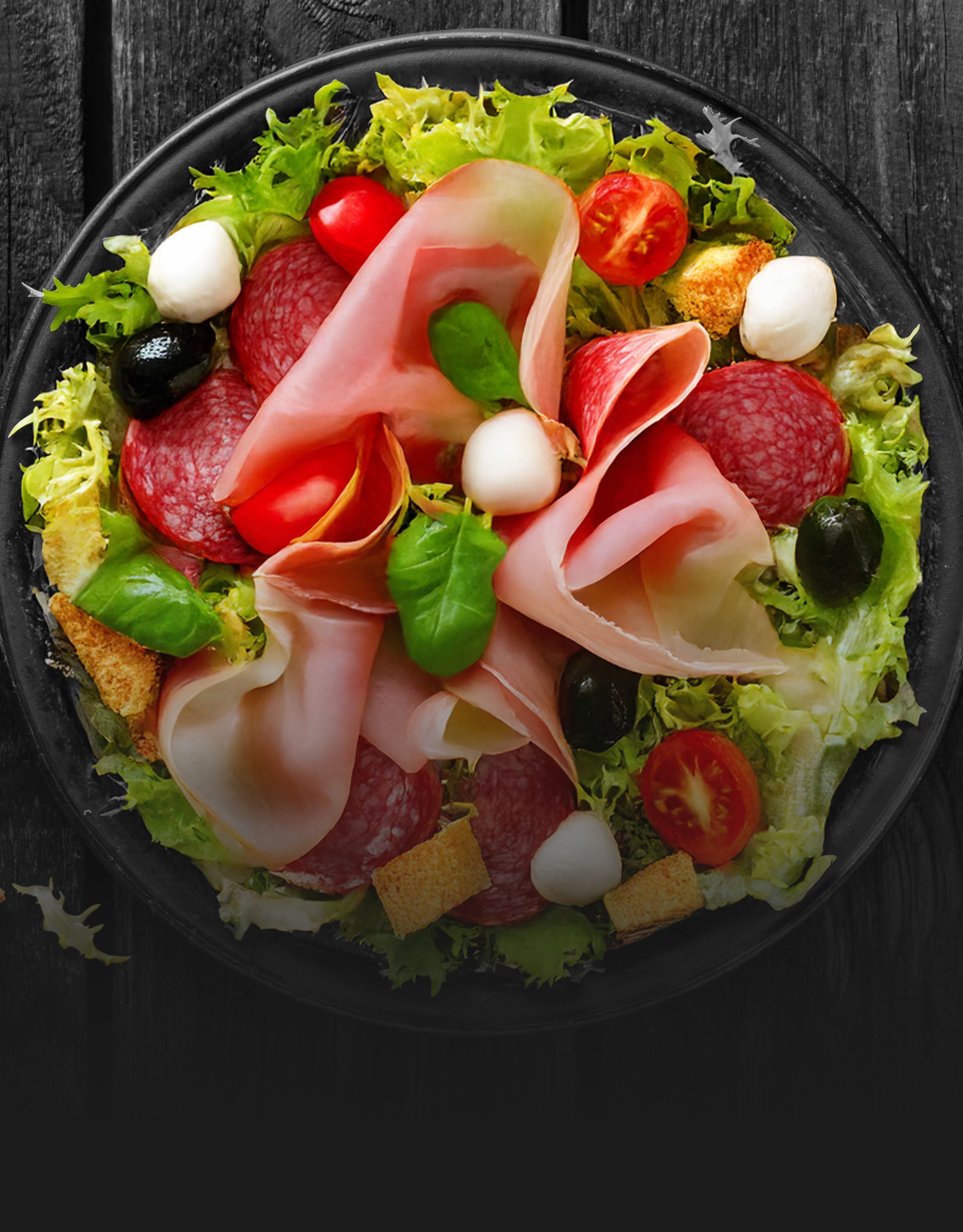 A close up of a salad on a plate on a table.