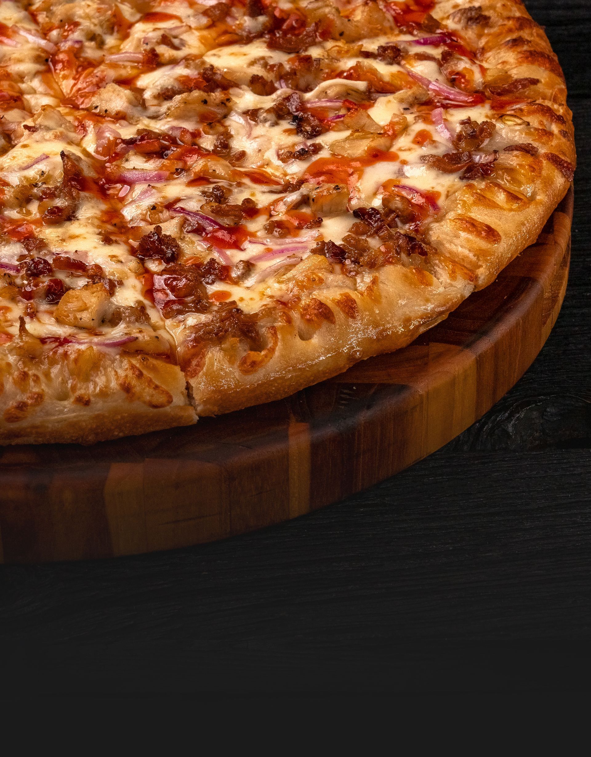 BBQ chicken pizza with tangy barbecue sauce, grilled chicken, and cheese on a wooden cutting board