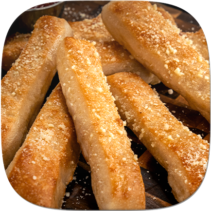 A plate of golden breadsticks sprinkled with Parmesan cheese