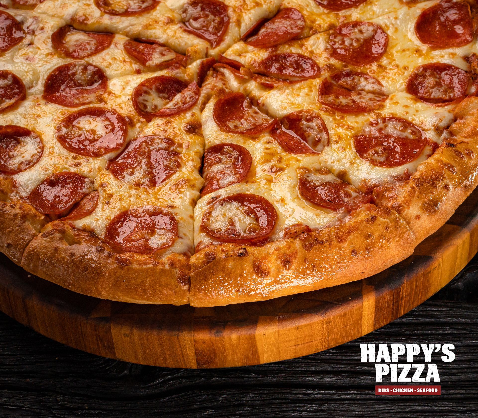 A pepperoni pizza is sitting on a wooden cutting board.