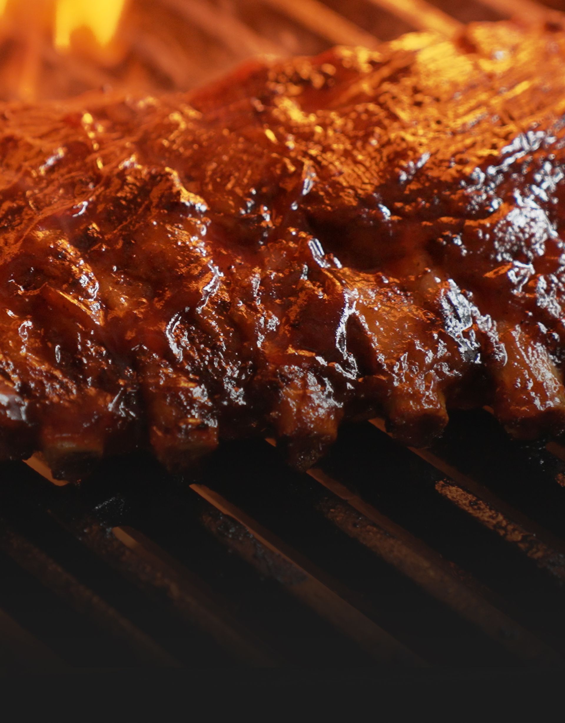 Tender BBQ ribs glazed with rich barbecue sauce, served hot off the grill.