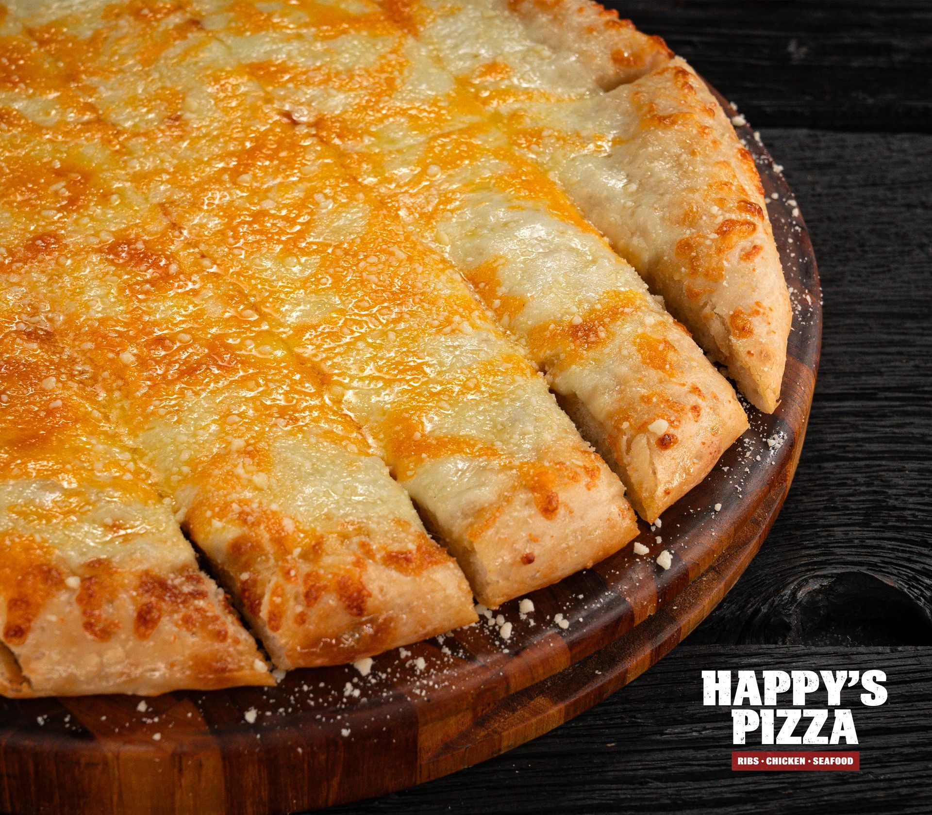 A pizza from happy 's pizza is on a wooden cutting board