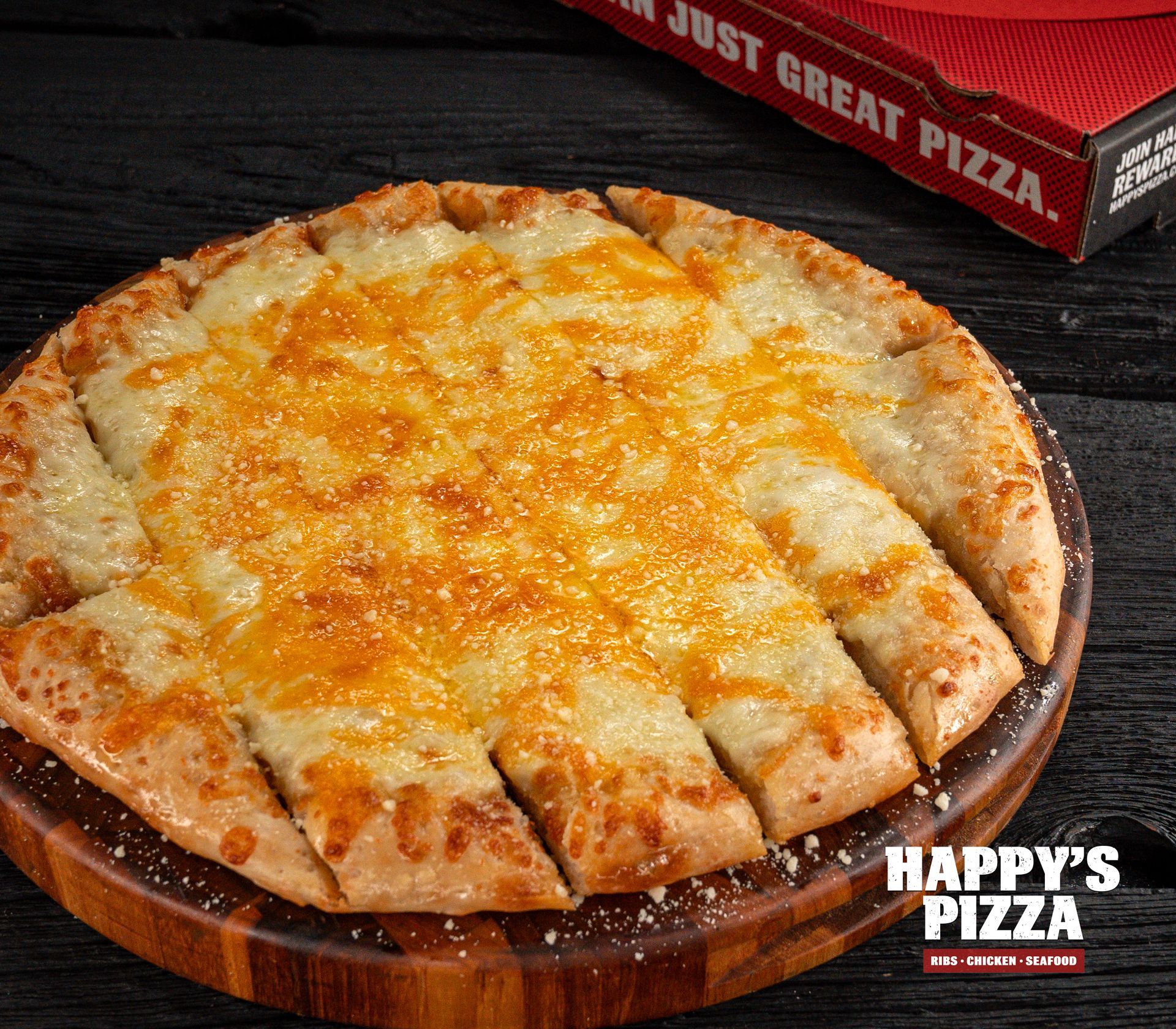 A pizza from happy 's pizza sits on a wooden cutting board