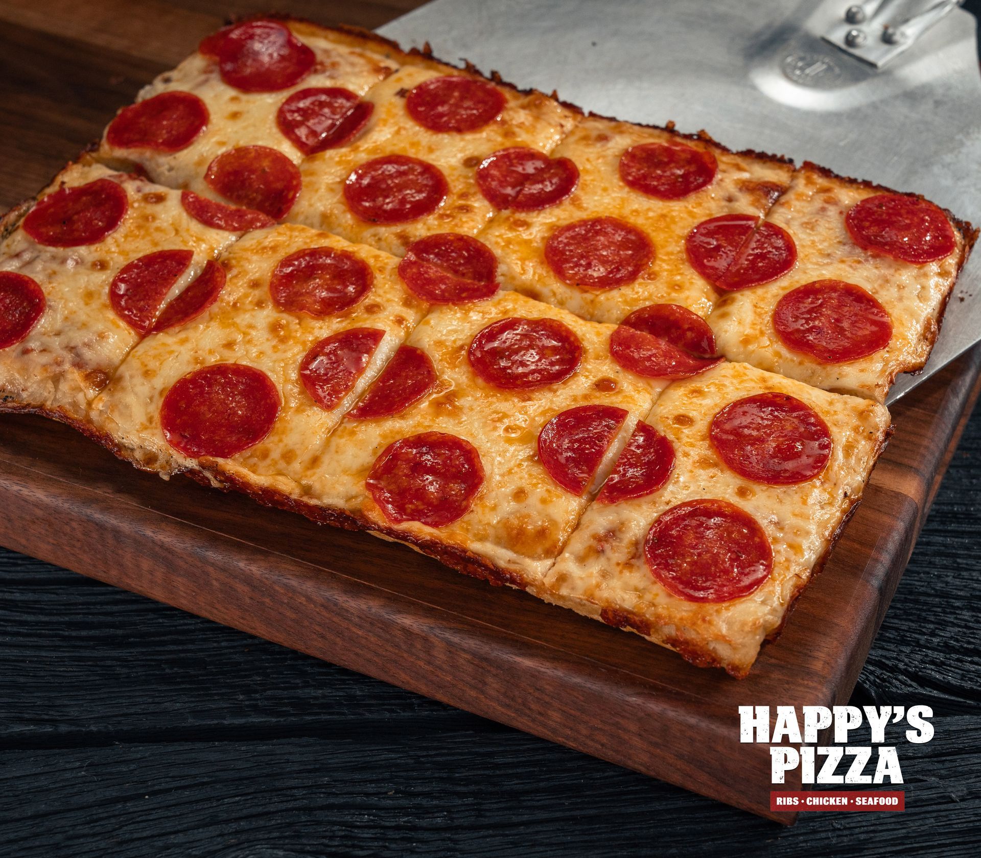 A pepperoni pizza from happy 's pizza on a wooden cutting board