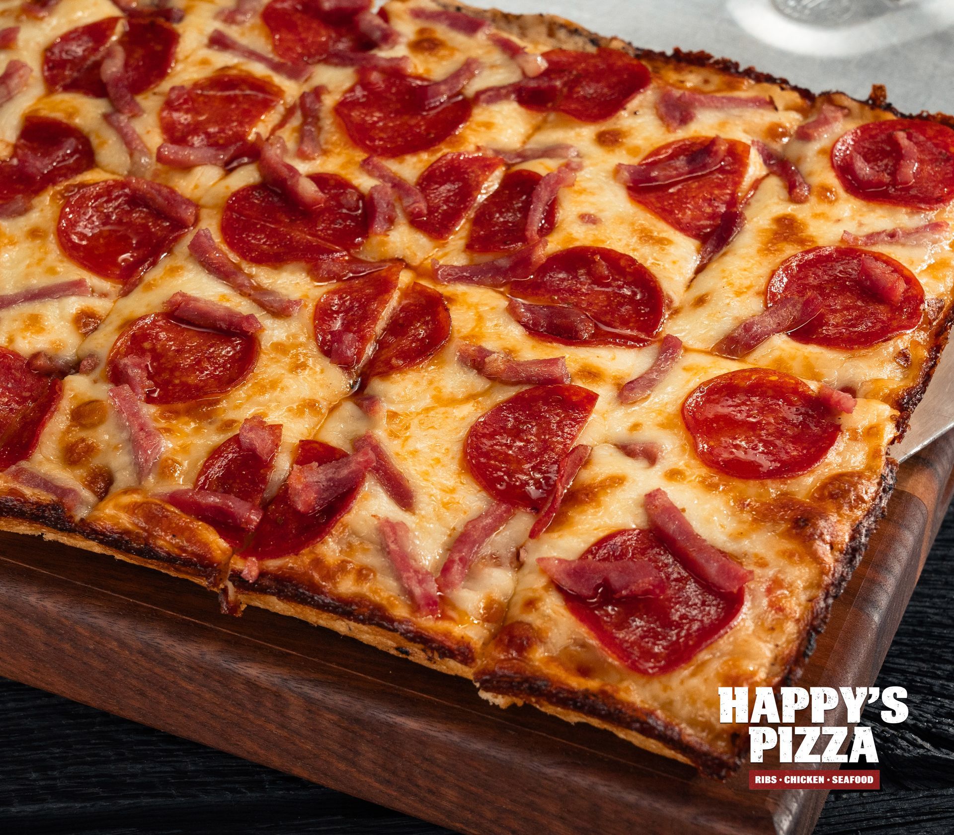 A pepperoni pizza from happy 's pizza on a wooden cutting board