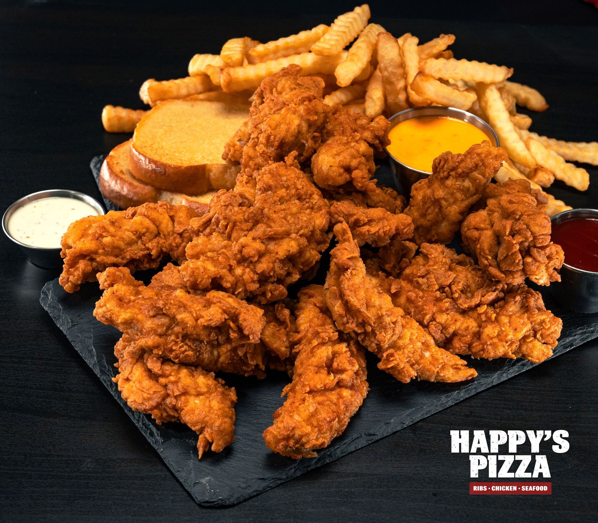 A tray of fried chicken and french fries from happy 's pizza
