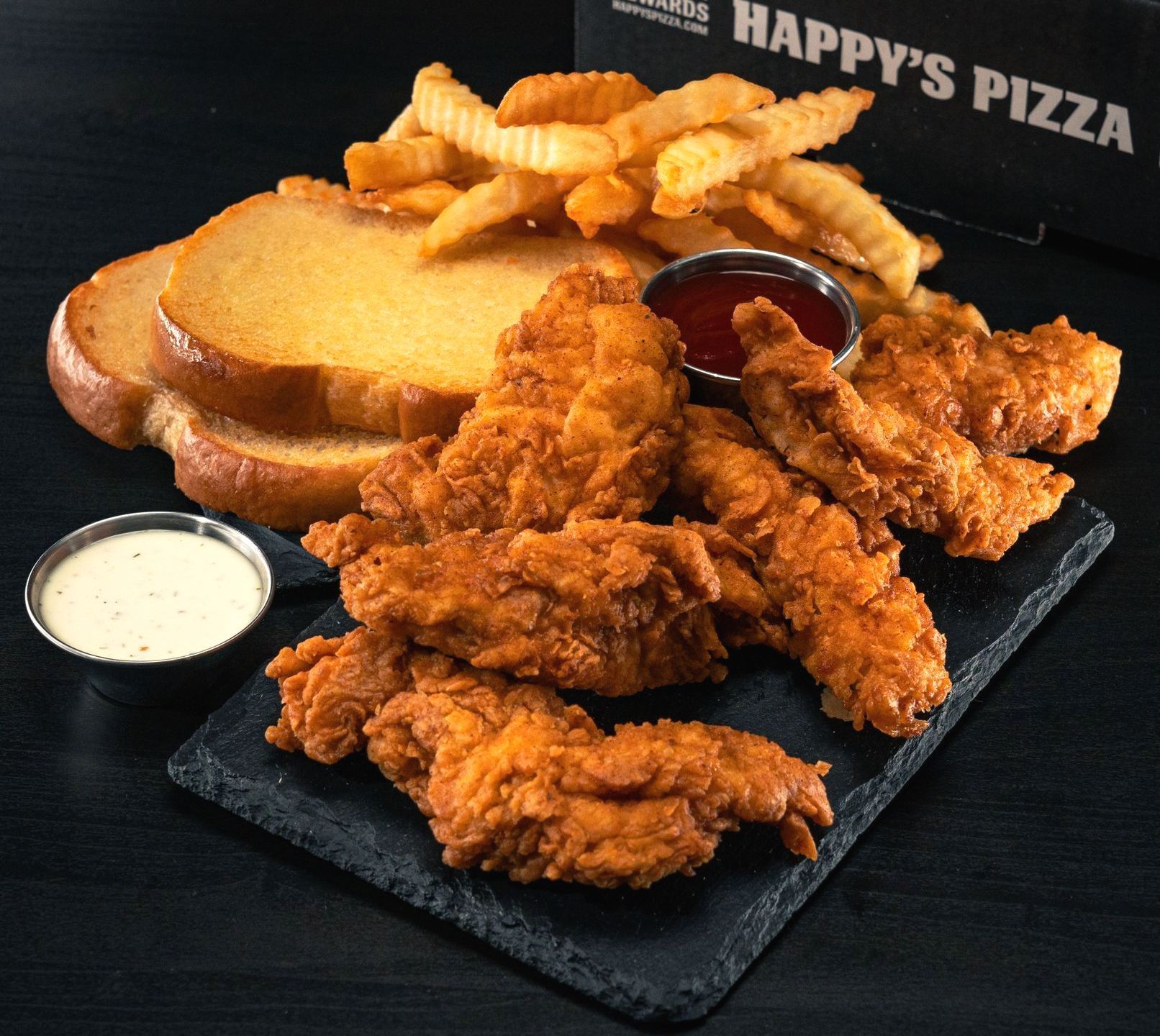 A plate of fried chicken and french fries from happy 's pizza