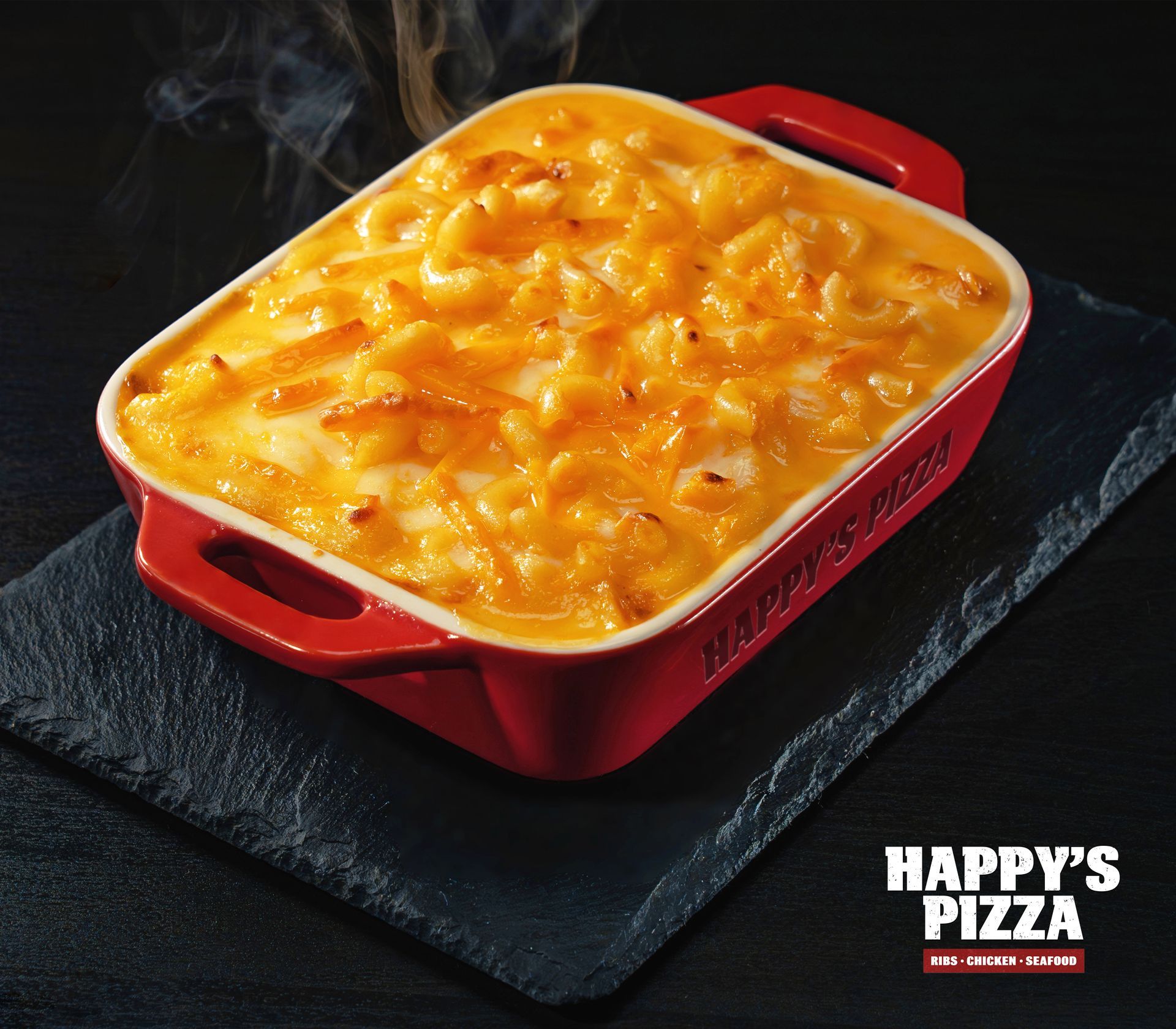 A casserole dish with macaroni and cheese from happy 's pizza