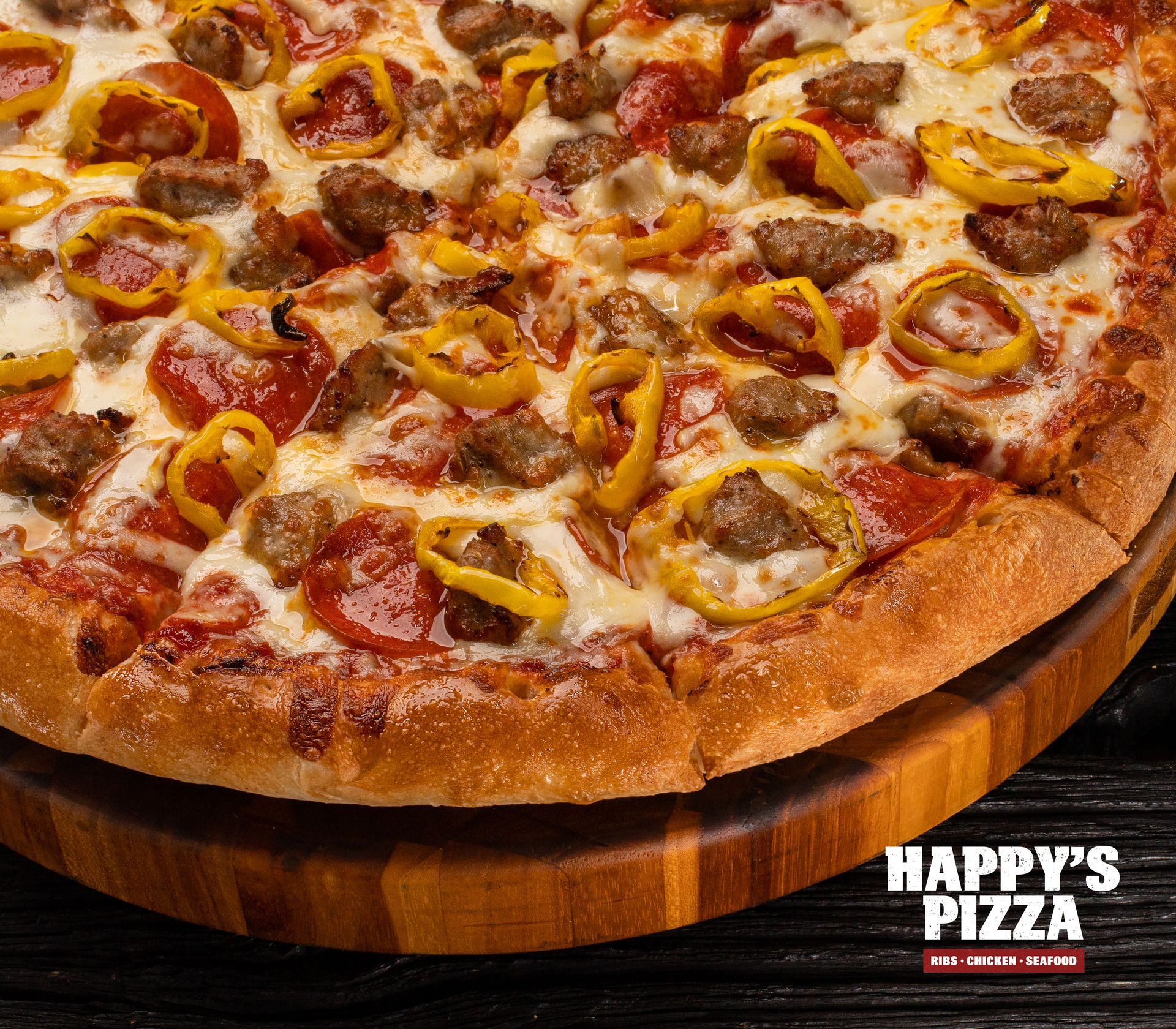 A pizza from happy 's pizza is on a wooden cutting board