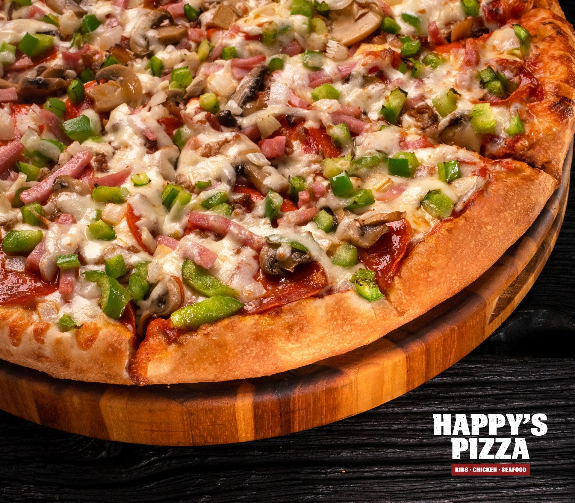 A pizza from happy 's pizza is on a wooden cutting board