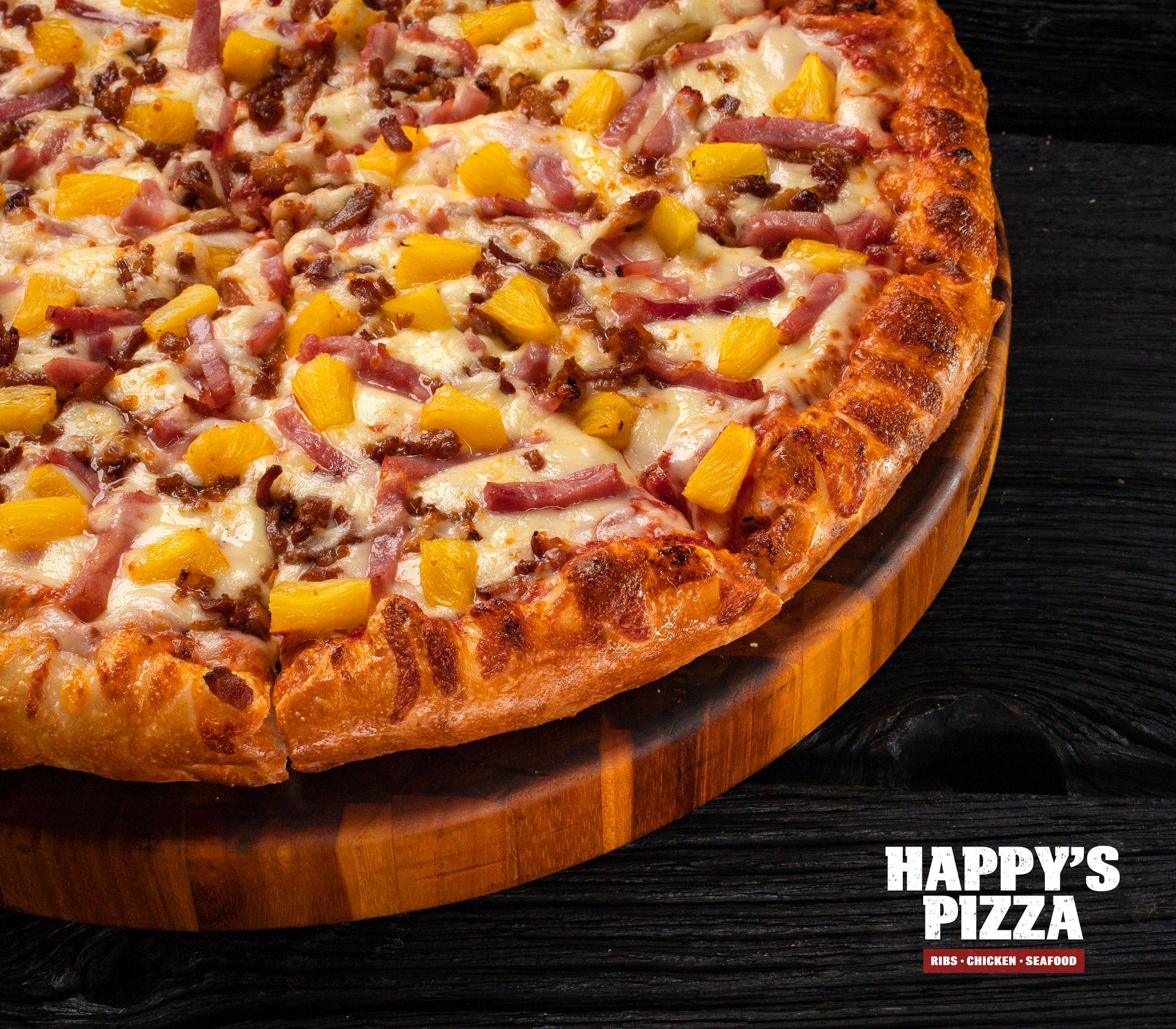 A pizza from happy 's pizza is on a wooden cutting board