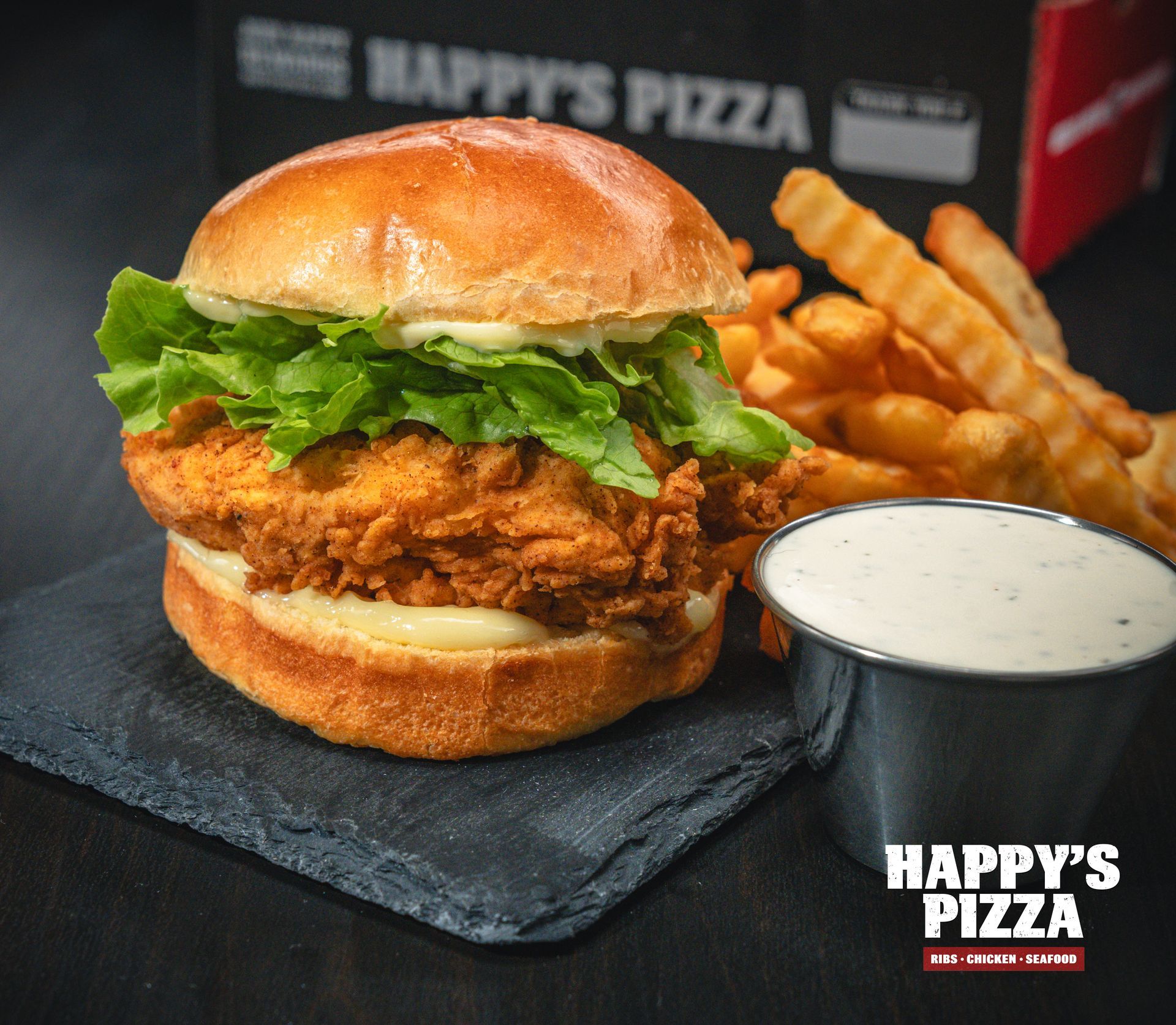 A chicken sandwich and french fries from happy 's pizza