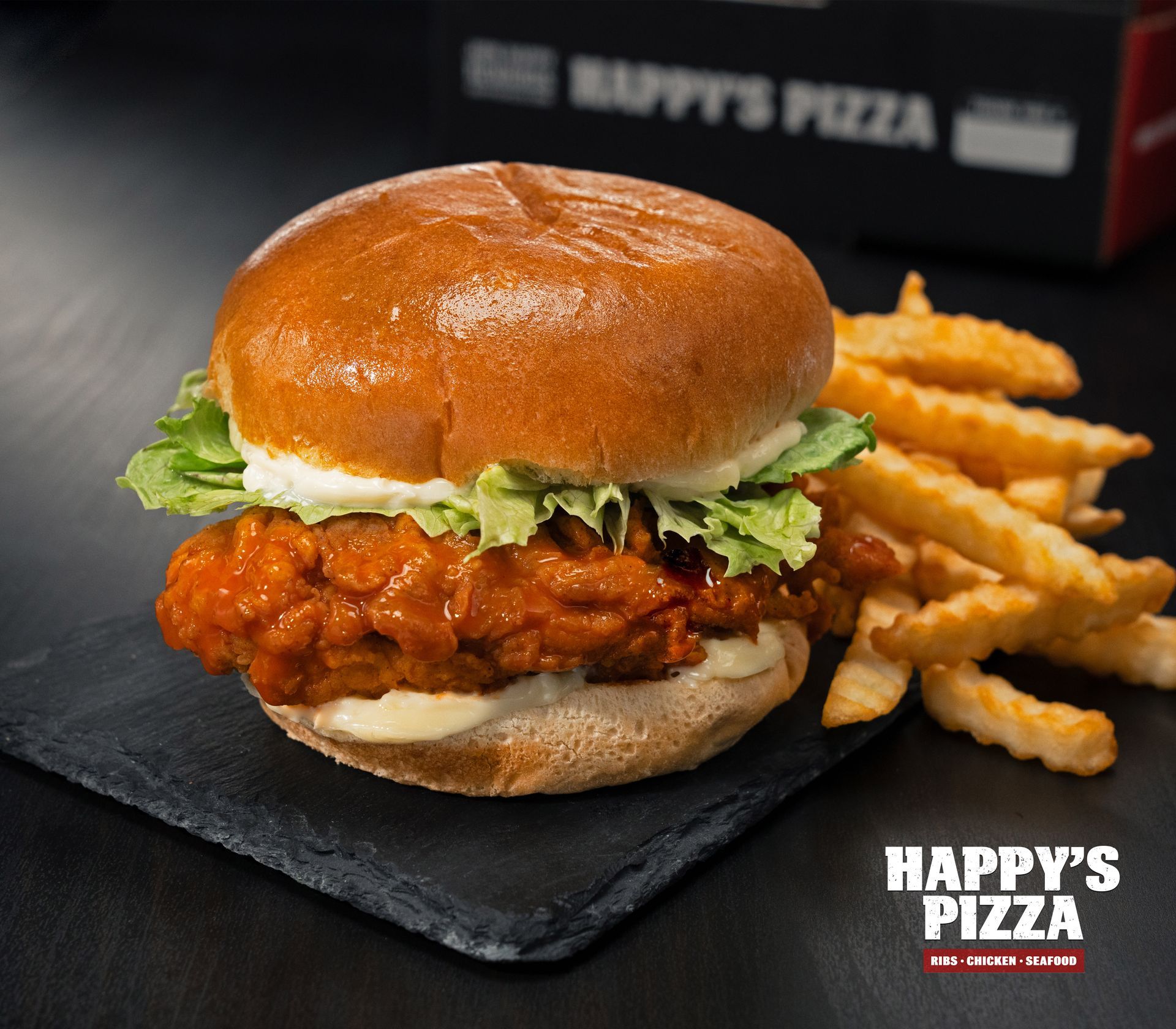 A chicken sandwich and french fries from happy 's pizza