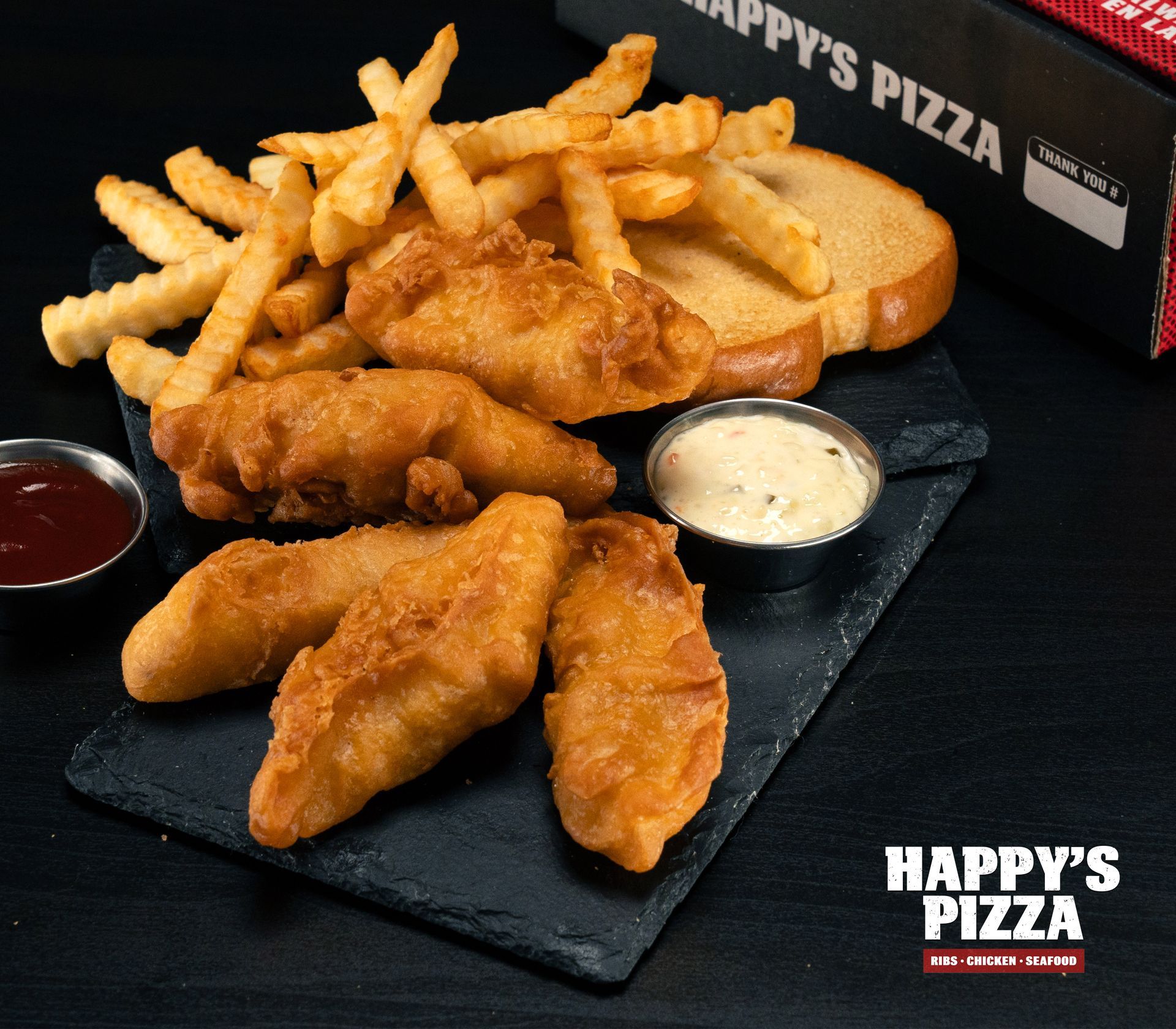 A plate of food from happy 's pizza with french fries and bread