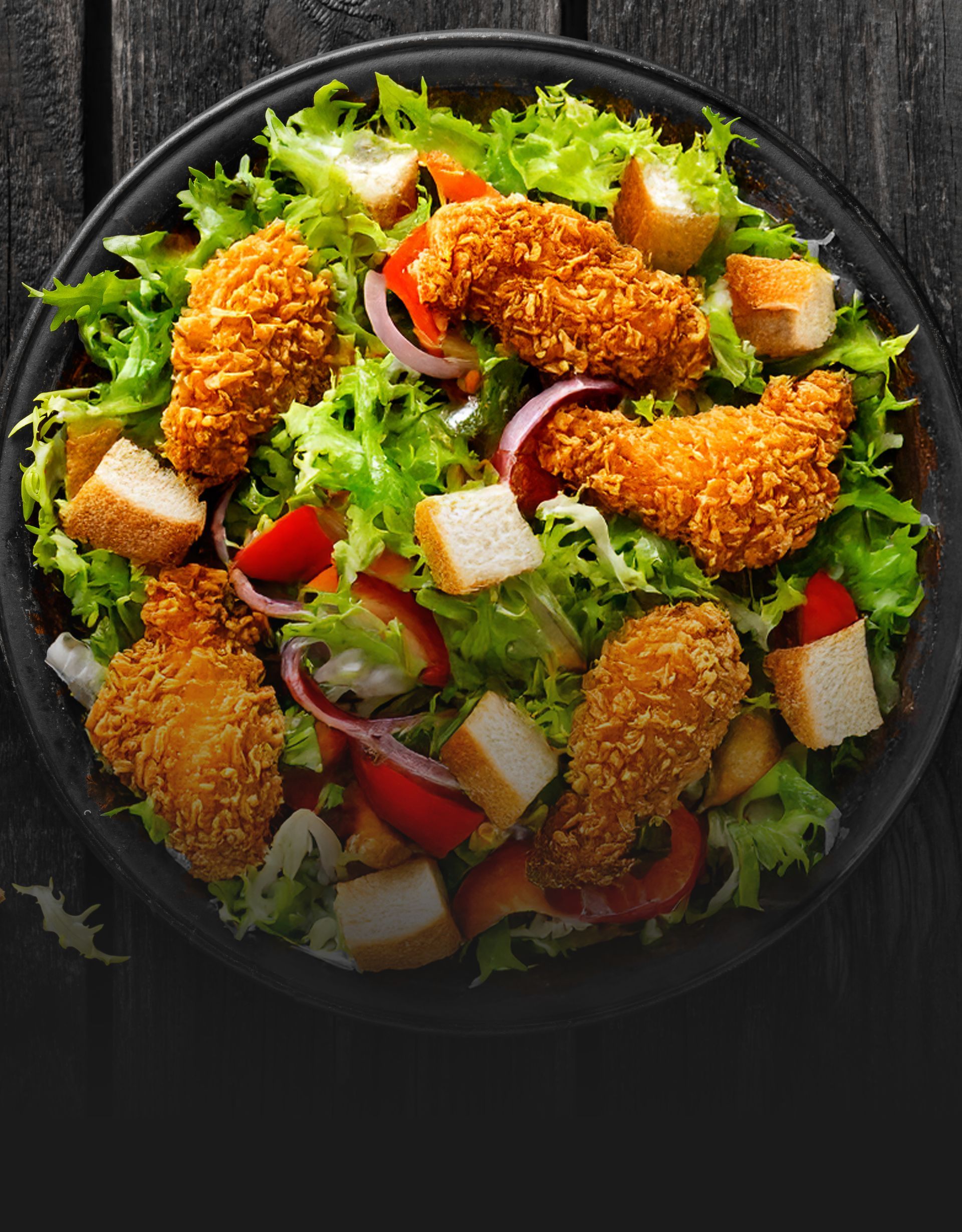 A close up of a salad on a plate on a table.