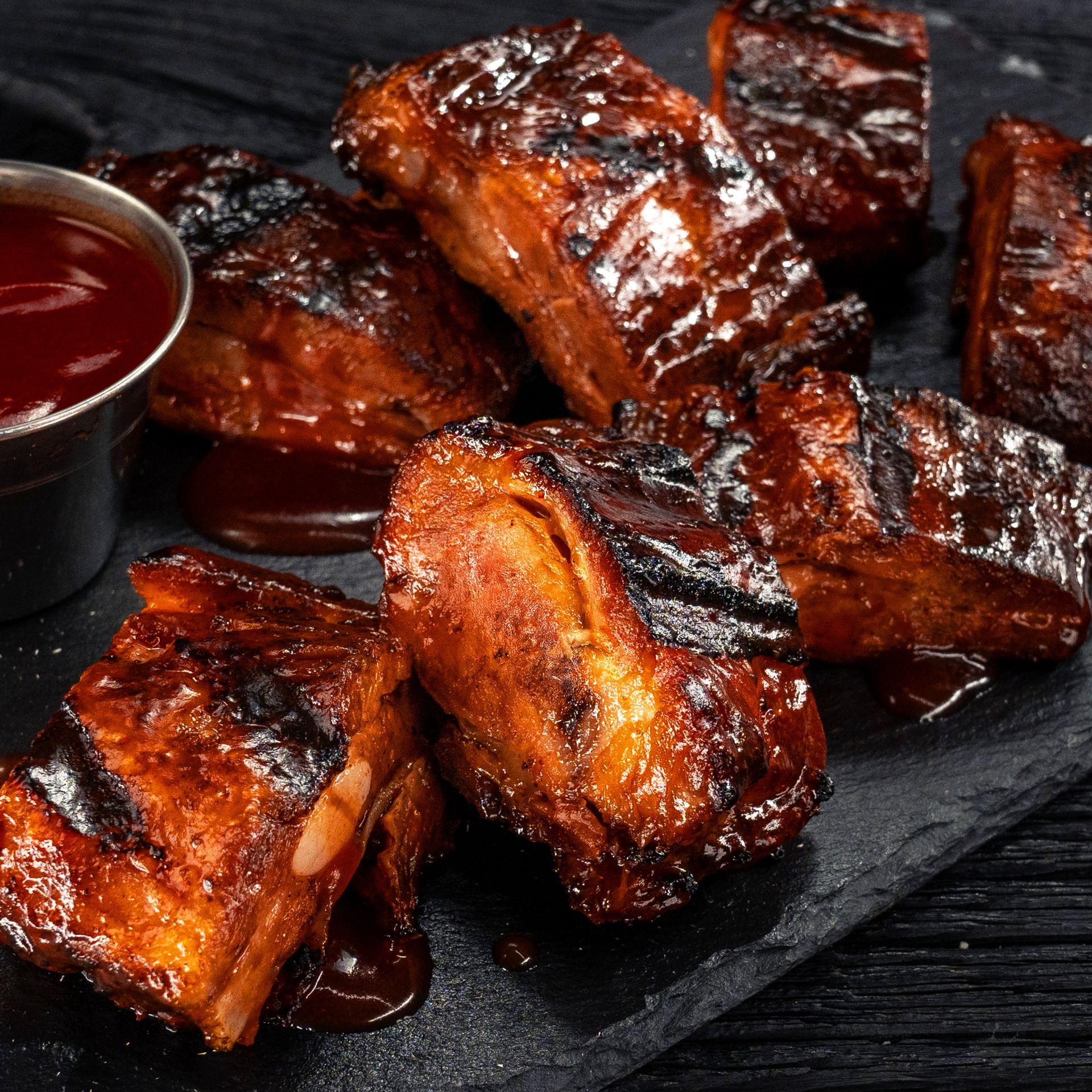 Juicy BBQ rib tips glazed in rich sauce, served as part of Happy's Pizza catering menu.
