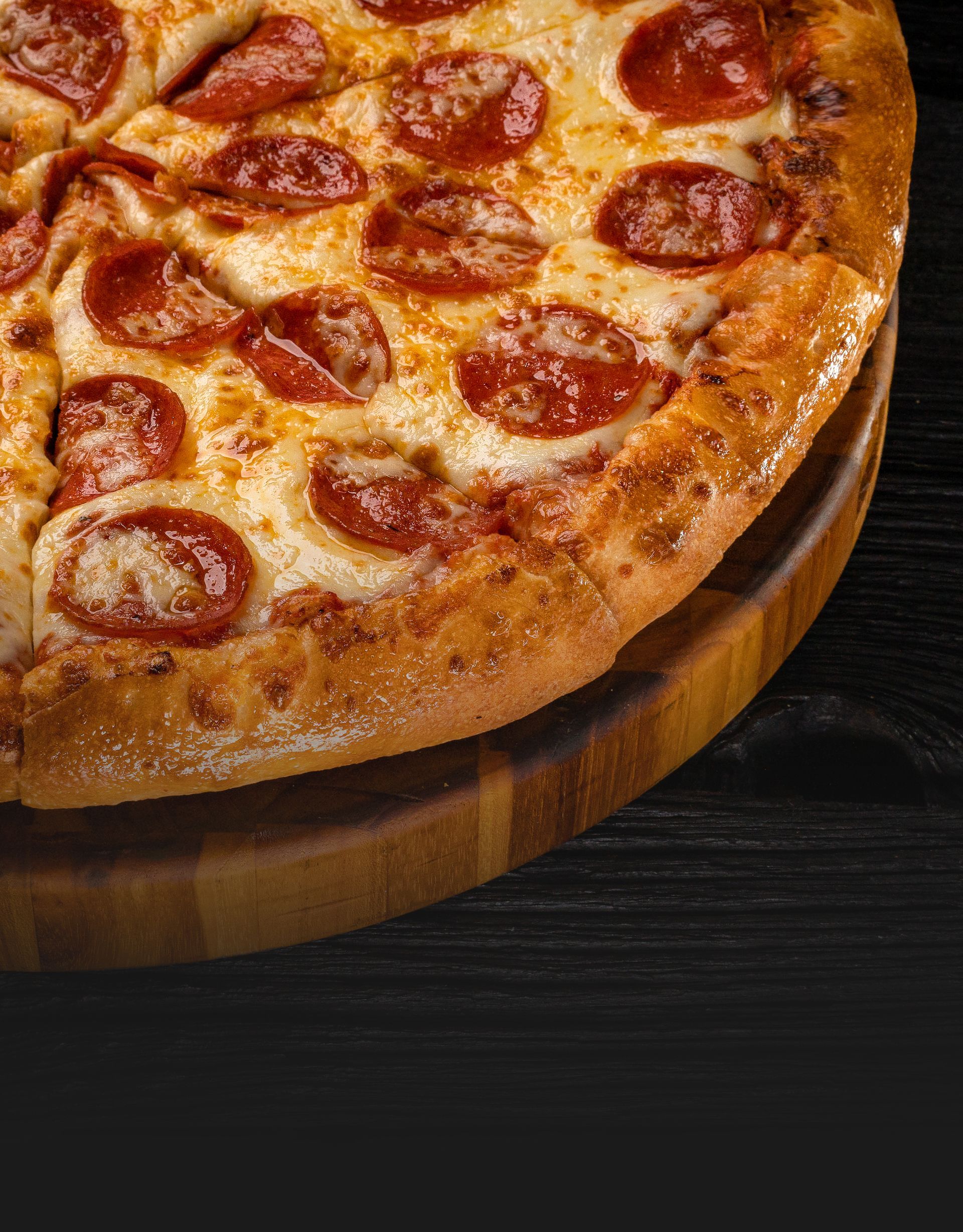 Classic pepperoni pizza on a wooden cutting board