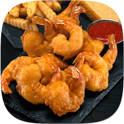 A plate of fried shrimp with french fries and cocktail sauce.