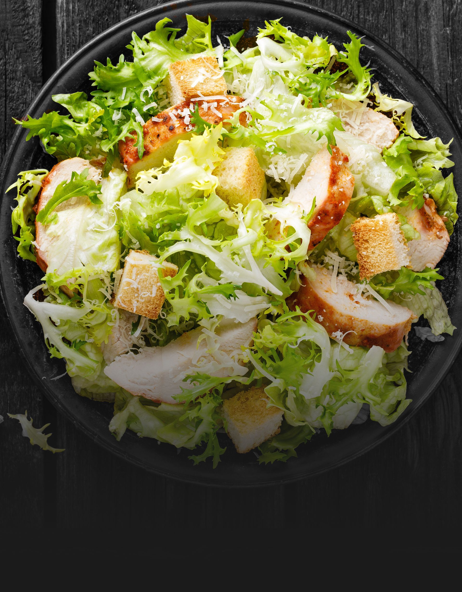 Crisp Caesar salad topped with grilled chicken, crunchy croutons, and shredded Parmesan cheese.