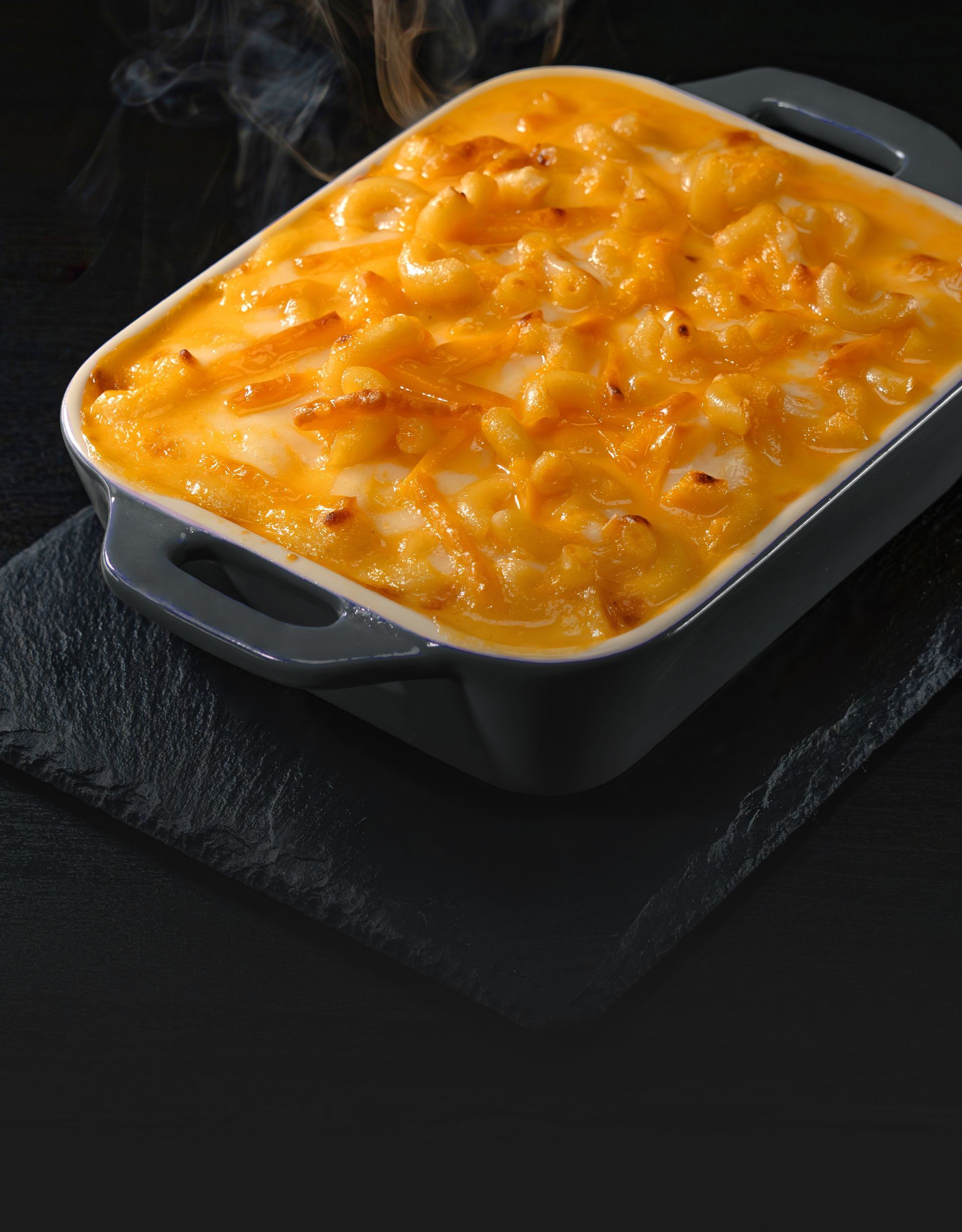 A casserole dish filled with macaroni and cheese on a table.