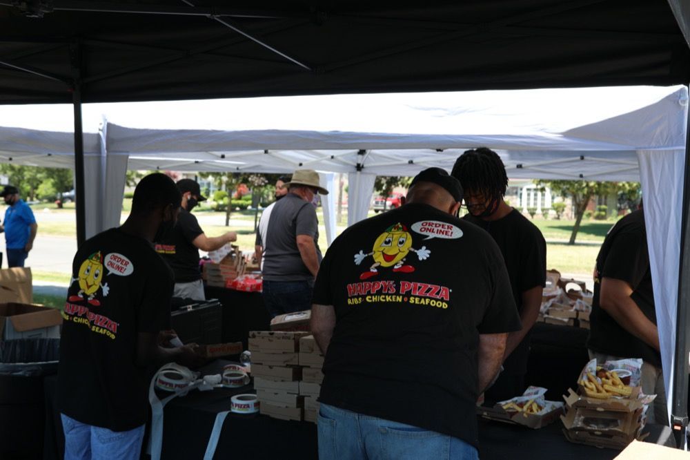 A group of people wearing black shirts with smiley faces on them