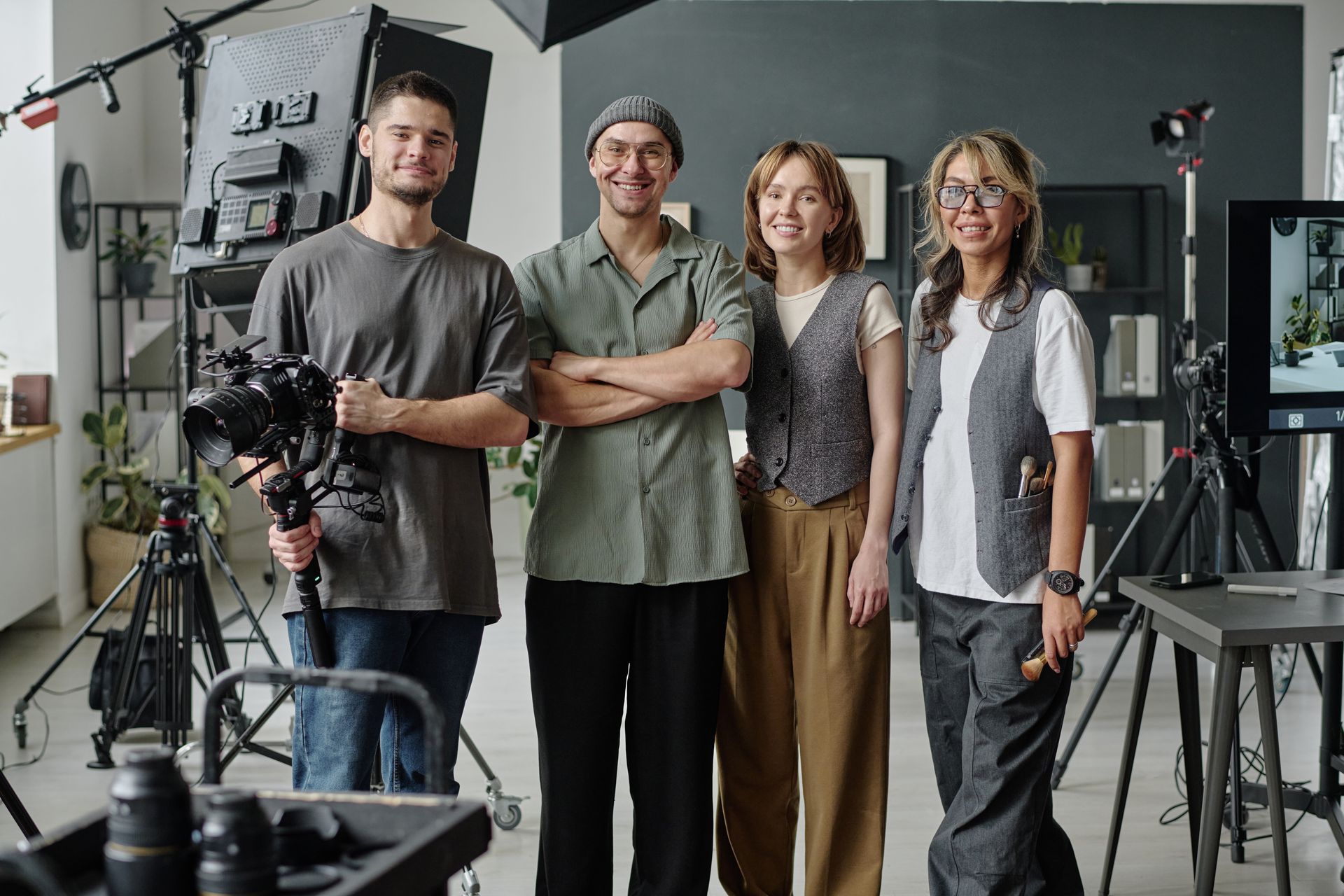 A group of people are posing for a picture in a studio.