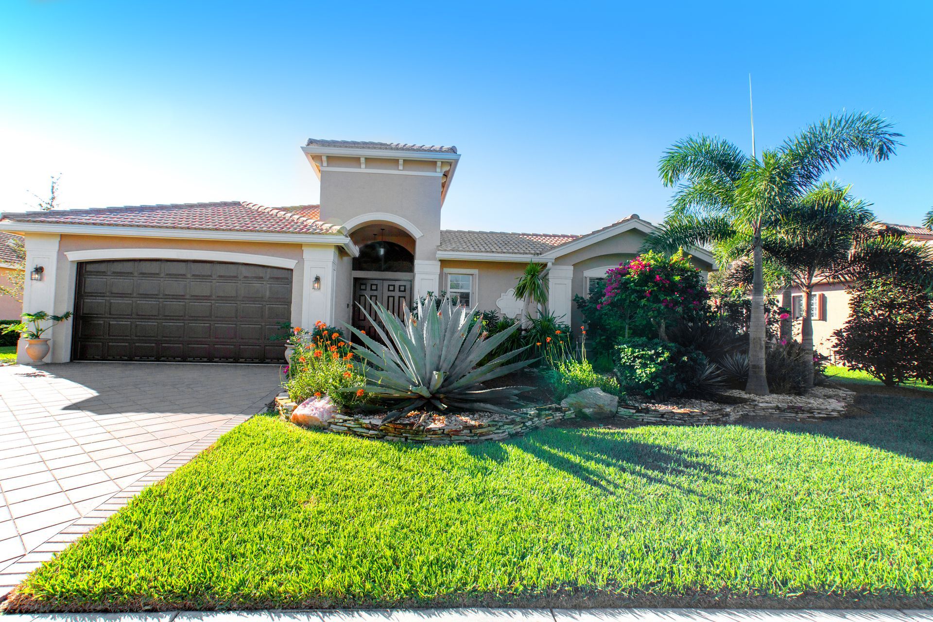 A house with a lush green lawn in front of it