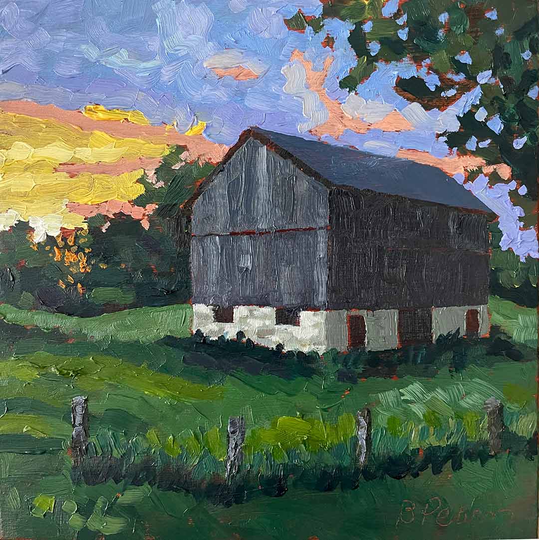 Barn with a scenic sunset.