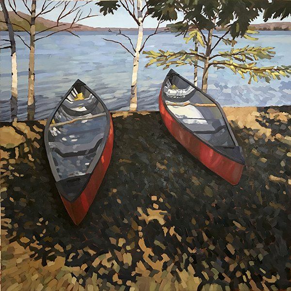 Two red canoes on shore