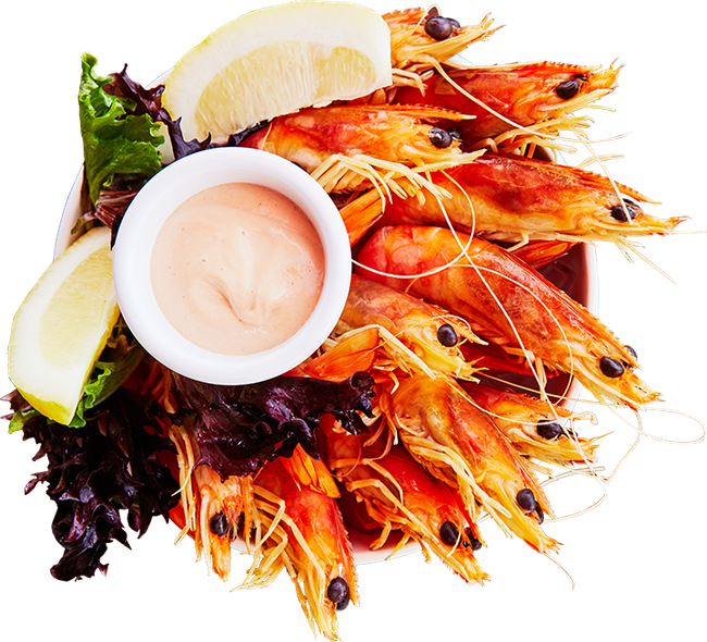 A plate of shrimp with a small bowl of dipping sauce